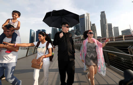 Howard, an Australian-Chinese impersonating North Korean leader Kim Jong Un, takes a stroll on Jubilee Bridge in Singapore May 27, 2018. REUTERS/Edgar Su