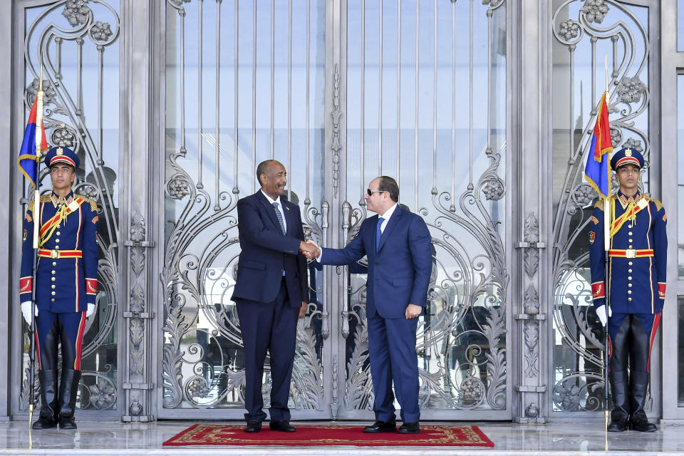 In this photo provided by Egypt's presidency media office, Egyptian President Abdel-Fattah el-Sissi, right, greets Sudan's army chief General Abdel Fattah al-Burhan at the Presidential palace in el-Alamein city, Egypt, Tuesday, Aug. 29, 2023. (Egyptian Presidency Media Office via AP)