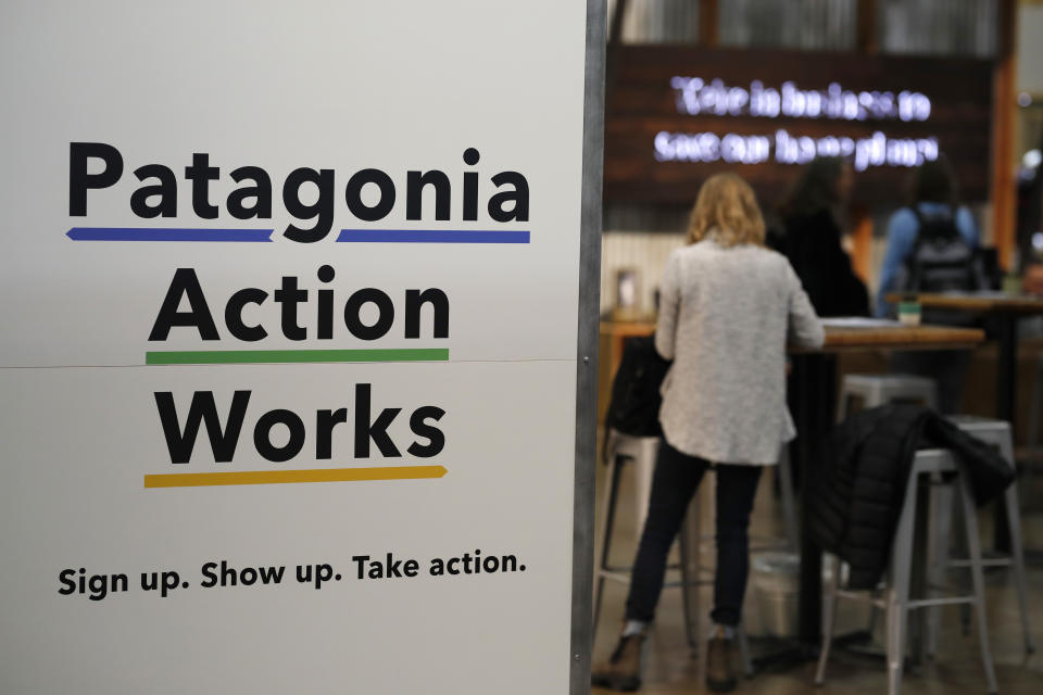 In this Wednesday, Jan. 30, 2019, photograph, a sign stands at the entrance to the Patagonia exhibit at the Outdoor Retailer & Snow Show in the Colorado Convention Center in Denver. Major players in the outdoor industry jumped into the political fight over national monuments two years ago and now have added climate change and sustainable manufacturing to their portfolio. (AP Photo/David Zalubowski)