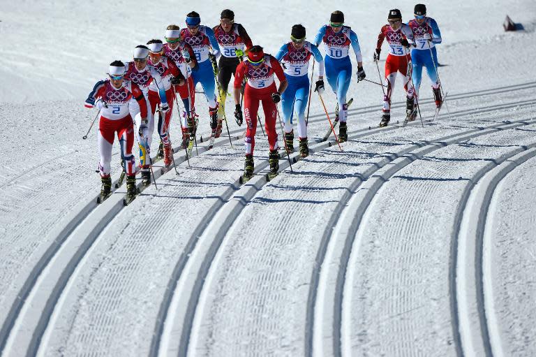(left to right) Norway's Marit Bjoergen and Poland's Justyna Kowalczyk compete in the Women's Cross-Country Skiing Skiathlon at the Laura Cross-Country Ski and Biathlon Center in Rosa Khuton on February 8, 2014