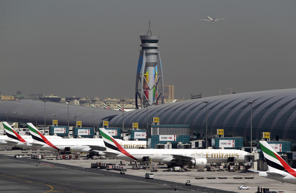 Emirates passenger planes are parked at their gates at Dubai airport in United Arab Emirates, Thursday, May 8, 2014. The parent company of the Middle East's biggest airline, Emirates, posted an annual profit Thursday of $1.1 billion as it enjoyed a dip in fuel costs and boosted capacity with the addition of two dozen new planes. (AP Photo/Kamran Jebreili)