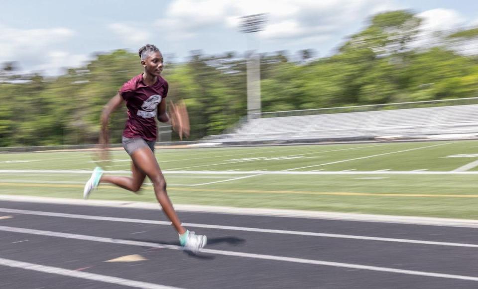 Sanu Jallow runs on the track at West Mecklenburg High School in Charlotte, N.C., on Tuesday, May 3, 2022.
