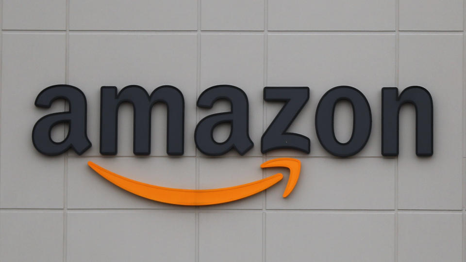 FTSE FILE - The Amazon DTW1 fulfillment center is shown in Romulus, Mich., April 1, 2020.  Big Tech companies reported mixed quarterly earnings on Thursday, July 30, 2020, a day after their top executives faced a tough congressional grilling over their market power and alleged monopolistic practices. (AP Photo/Paul Sancya, File)