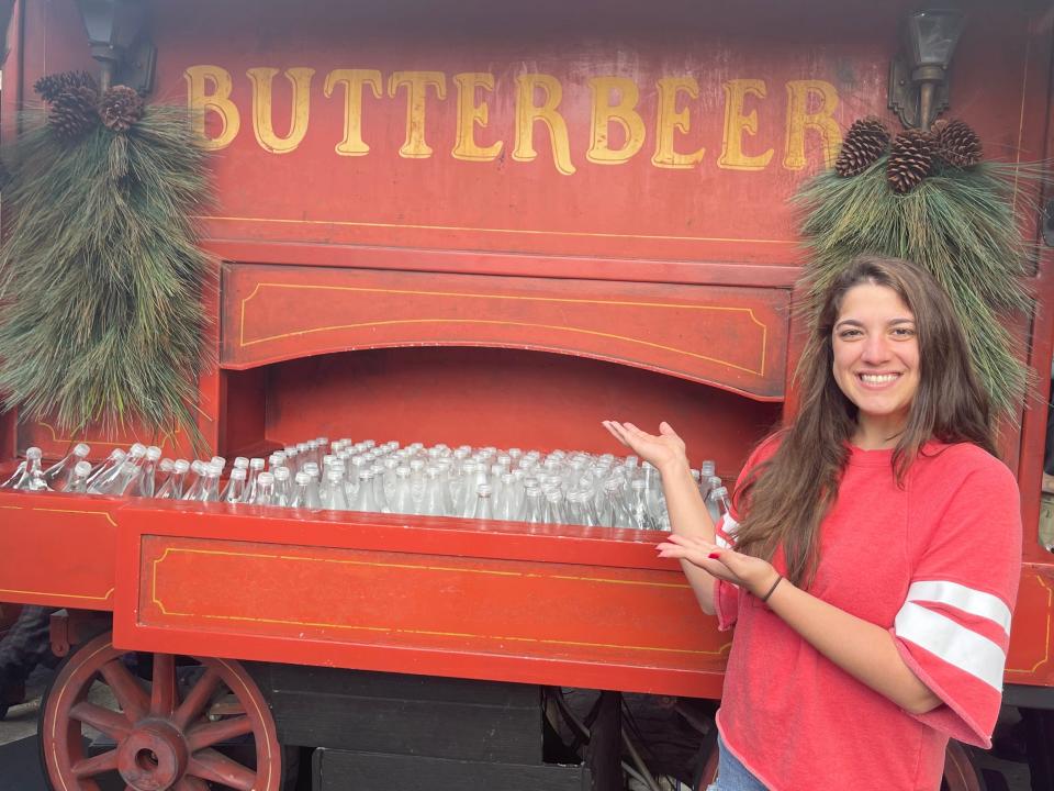 elizabeth blasi standing in front of a butterbeer cart