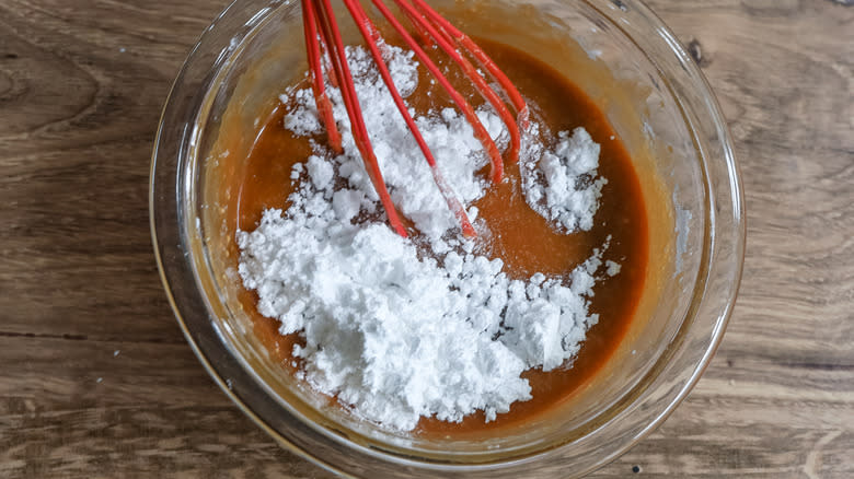 adding powdered sugar to caramel