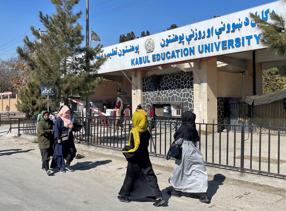 Female students walk in front of the Kabul Education University in Kabul, Afghanistan, February 26, 2022. REUTERS/Stringer