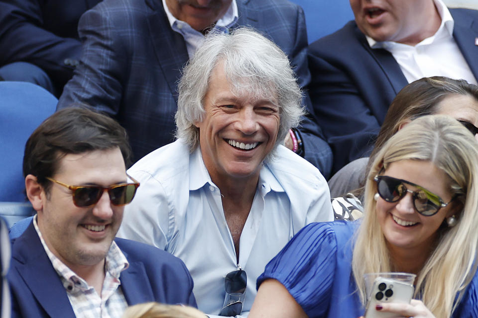 Close-up of Jon smiling and sitting in a crowd