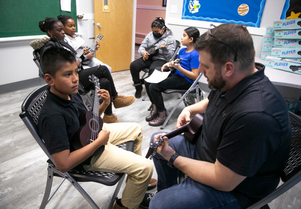 Saul Sanchez, 11, gets a ukulele lesson from Major Josh Lyle. Children of Asbury Park are offered free music lessons through a program at the Salvation Army.    Asbury Park, NJThursday, November 17, 2022