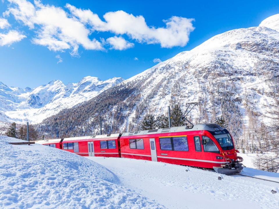 Bernina Express train in the snowy landscape of Engadin, Switzerland.
