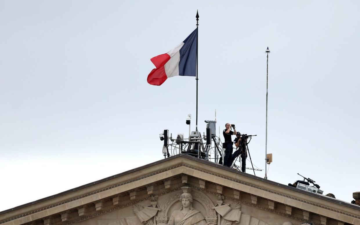 Armed Police are seen on top of the The National Assembly building