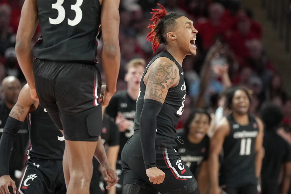 Cincinnati guard Jeremiah Davenport, right, reacts after making a 3-point basket during the first half of an NCAA college basketball game against Houston, Saturday, Jan. 28, 2023, in Houston. (AP Photo/Eric Christian Smith)