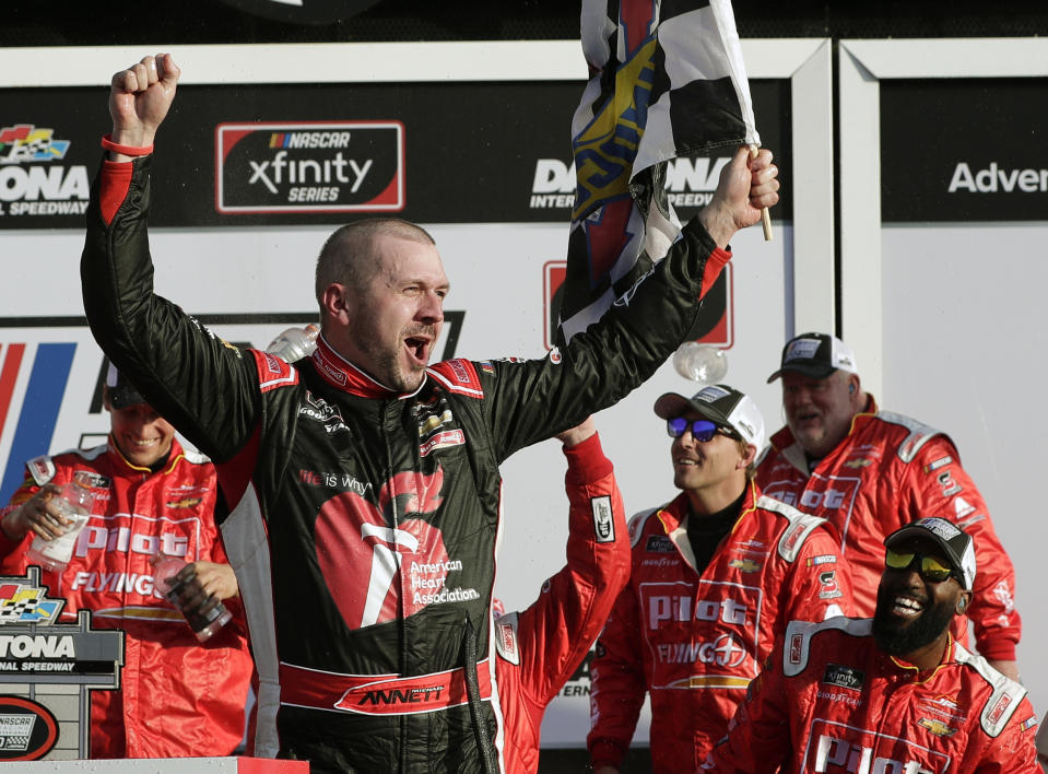 Michael Annett celebrates in Victory Lane after winning the NASCAR Xfinity series auto race at Daytona International Speedway, Saturday, Feb. 16, 2019, in Daytona Beach, Fla. (AP Photo/John Raoux)