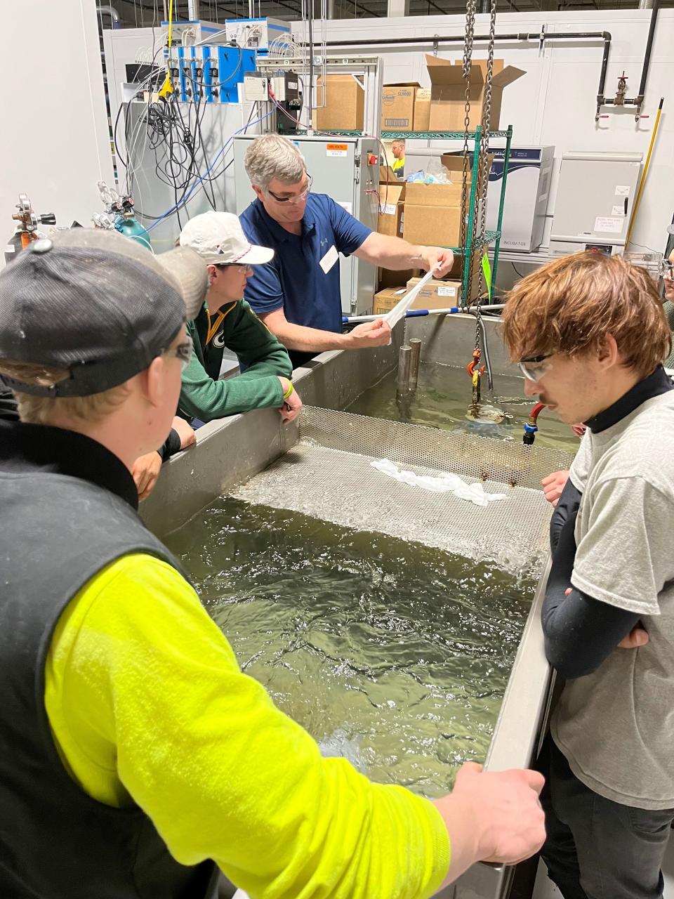 Pete Lortscher shows plumbing students from Fox Valley Technical College what a baby wipe looks like after going through a pump at Kimberly-Clark's Flushability Lab in Neenah, Wisc., on Jan. 25.