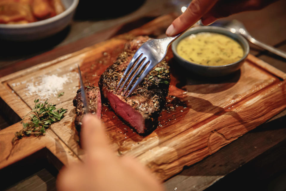 Cutting a steak on a cutting board