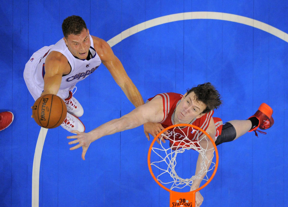 Los Angeles Clippers forward Blake Griffin, left, puts up a shot as Houston Rockets center Omer Asik, of Turkey, defends during the first half of an NBA basketball game, Wednesday, Feb. 26, 2014, in Los Angeles. (AP Photo/Mark J. Terrill)