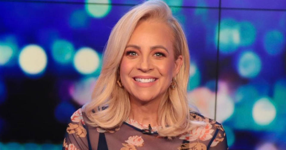 Carrie Bickmore smiles at the camera on the set of The Project