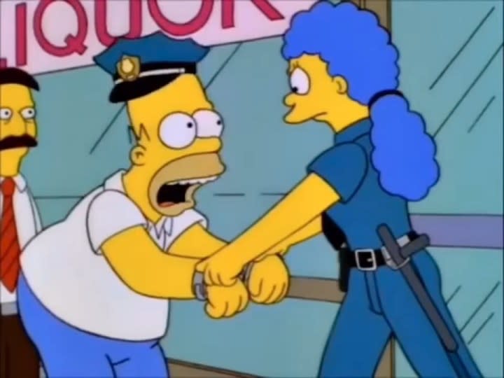 Marge handcuffing Homer in "The Simpsons."