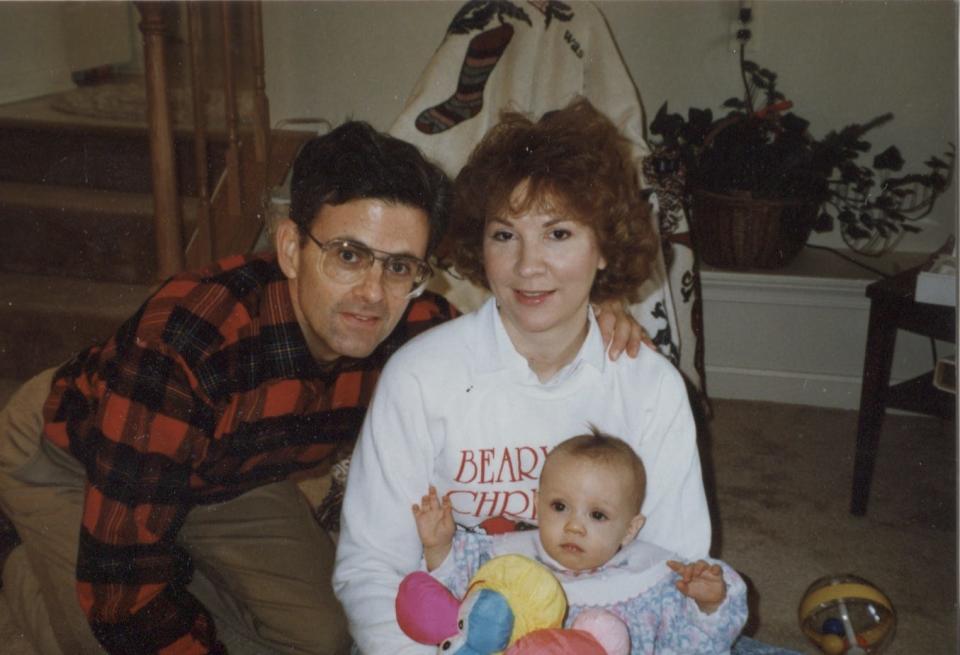 Jonathan, Debbie and Ashley May pose for a photo around the holidays when Ashley was a baby.