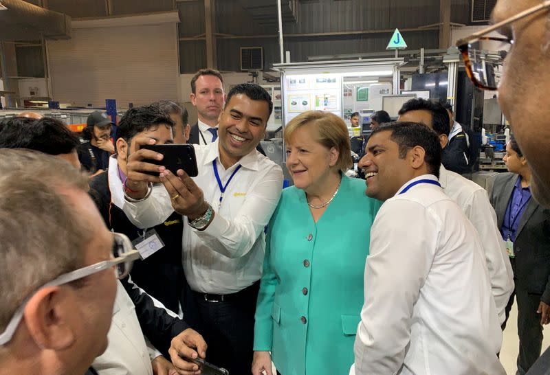 FILE PHOTO: German Chancellor Angela Merkel visits Continental Automotive Components India Pvt Ltd plant at Manesar