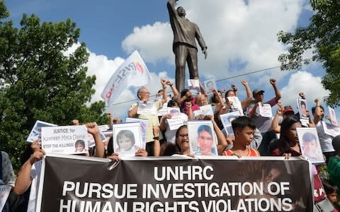 Relatives of victims of Philippines drugs war call for an investigation into human rights violations - Credit: Ted Aljibe/AFP