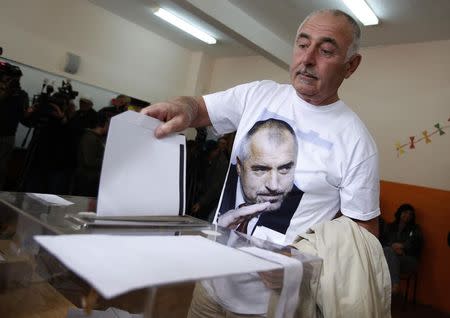 A man, wearing a T-shirt with an image of Boiko Borisov, leader of Bulgaria's centre right GERB party, casts his vote in Sofia October 5, 2014. REUTERS/Stoyan Nenov