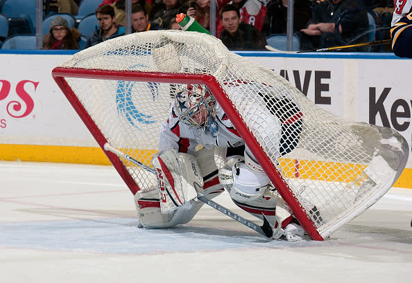 BUFFALO, NY - DECEMBER 09: The goal net tips over atop Philipp Grubauer #31 of the Washington Capitals during an NHL game against the Buffalo Sabres at the KeyBank Center on December 9, 2016 in Buffalo, New York. Washington won, 4-1. (Photo by Gary Wiepert/NHLI via Getty Images)