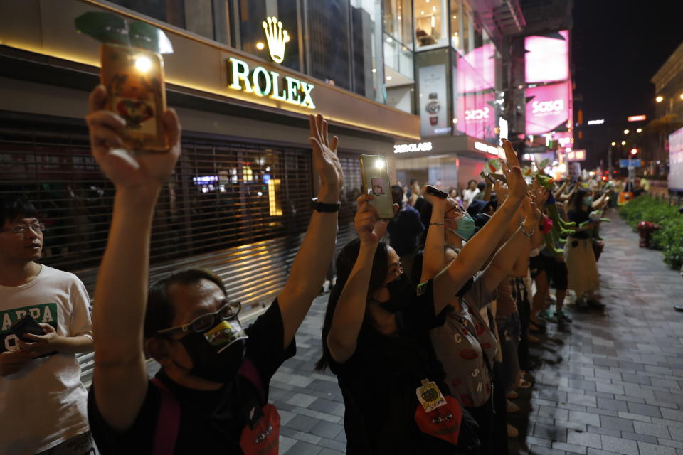 People form a human chain in support of protest movement in Hong Kong, Monday, Sept. 30, 2019. Hong Kong police warned Monday of the potential for protesters in the semi-autonomous Chinese territory to engage in violence "one step closer to terrorism" during this week's National Day events, an assertion ridiculed by activists as propaganda meant to scare people from taking to the streets. (AP Photo/Vincent Thian)