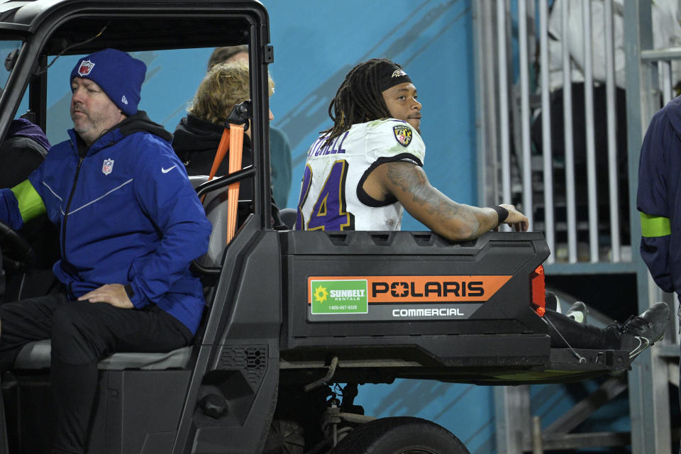 Baltimore Ravens running back Keaton Mitchell is taken off the field in the second half of an NFL football game against the Jacksonville Jaguars Sunday, Dec. 17, 2023, in Jacksonville, Fla. (AP Photo/Phelan M. Ebenhack)