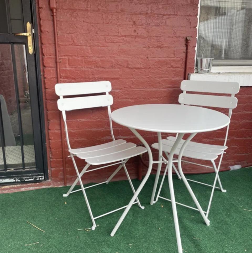 the white bistro set on outdoor patio