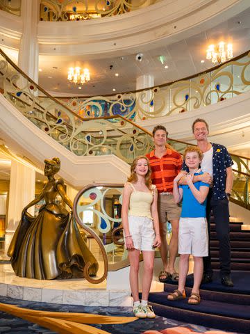 <p>Abigail Nilsson/Disney</p> Neil Patrick Harris, David Burtka and their twins in the Grand Hall of the Disney Wish