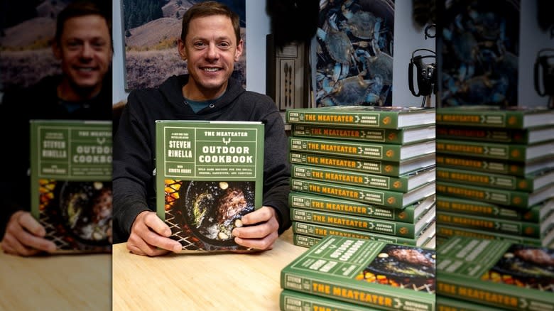 Man holding a green cookbook