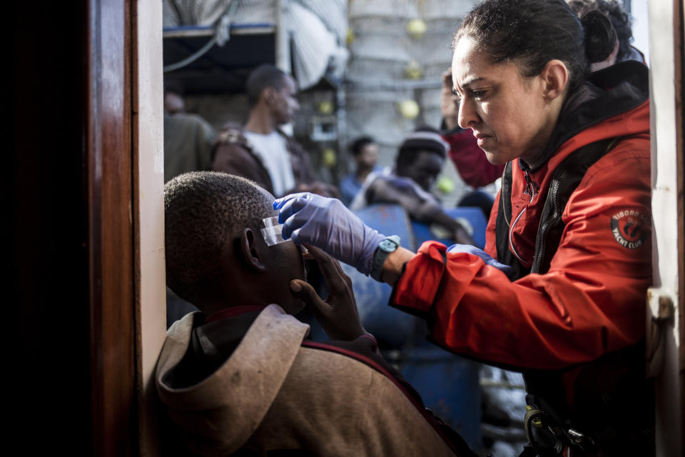 In this photo taken on Saturday, Nov. 24, 2018 photo, a migrant receives medical assistance after being rescued by Nuestra Madre de Loreto, a Spanish fishing vessel, two days ago off the Libyan shore. The Spanish NGO Proactiva Open Arms carried medical checks and provided food, clothes and blankets to the migrants. (AP Photo/Javier Fergo)