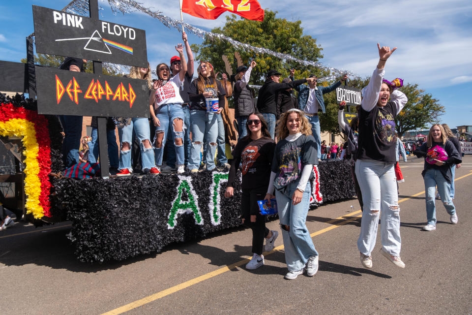 Members of Chi Omega and Alpha Gamma Rho salute the "Golden Age of Rock" Saturday afternoon at the WT Homecoming Parade in Canyon.