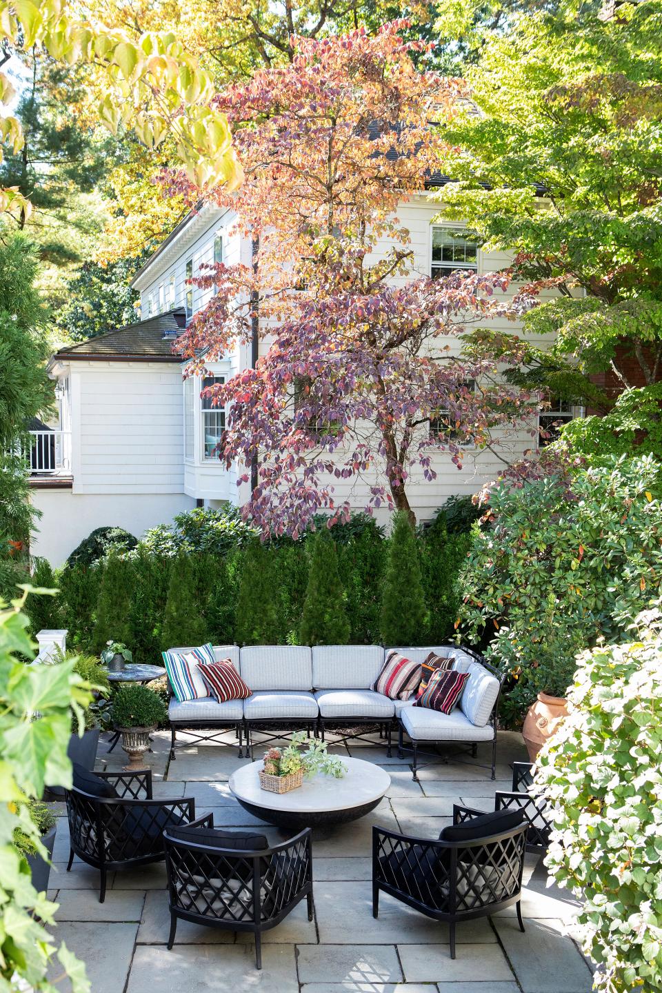 “The intent here was to create different [areas in which] people could enjoy the exterior world and have fun with family and friends,” says Galli. The terrace space is centered around a custom fire pit, designed by R.T. Facts. The sectional fabric is by Maria Flora, and the lounge chairs are from RH.