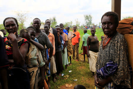 South Sudanese families displaced by fighting queue for vaccination in Lamwo after fleeing fighting in Pajok town across the border in northern Uganda, April 5, 2017. REUTERS/James Akena