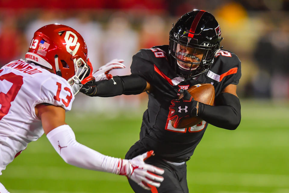 LUBBOCK, TX - NOVEMBER 03: Ta'Zhawn Henry #26 of the Texas Tech Red Raiders gets past Tre Norwood #13 of the Oklahoma Sooners during the first half of the game on November 3, 2018 at Jones AT&T Stadium in Lubbock, Texas. (Photo by John Weast/Getty Images)