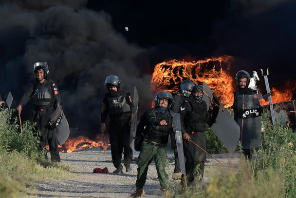 PHOTO: Police officers throw stones towards supporters of Pakistan's former Prime Minister Imran Khan during clashes, in Islamabad, Pakistan, Wednesday, May 10, 2023. (AP)