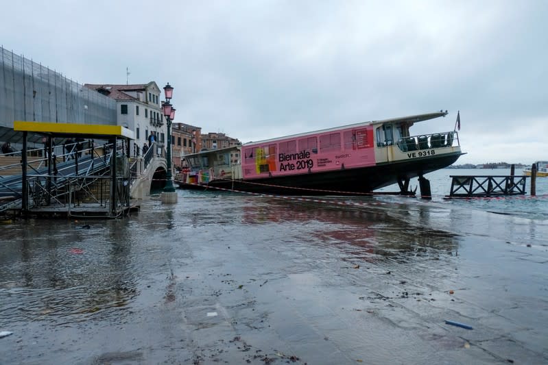 Vaporetto transported by the water after a night of record-high water levels is seen on the shore in Venice