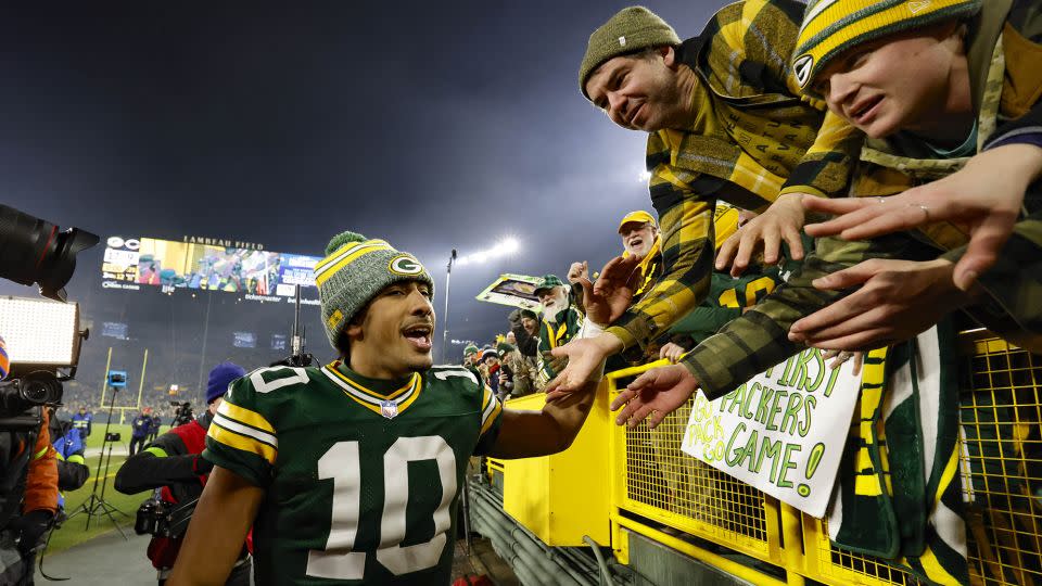Love celebrates with fans after beating the Bears. - Jeffrey Phelps/AP