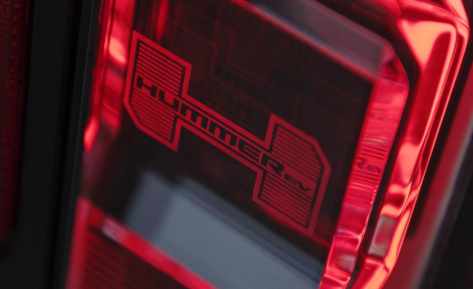 <p>Just as Jeep puts tiny Jeep grilles in the headlights of a Wrangler or Compass, GMC has put the Hummer EV badging in the truck's taillights. </p>