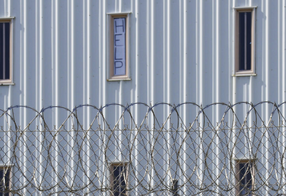 FILE - In this Oct. 22, 2019, file photo, a sign reads, "HELP," in the window of an inmate cell seen during a tour by state officials at Holman Correctional Facility in Atmore, Ala. Alabama lawmakers return to Montgomery on Monday, Sept. 27, 2021, to vote on a $1.3 billion prison construction plan proponents say will help address the state’s longstanding problems in corrections, but critics argue the troubles go much deeper and won’t be remedied with brick, mortar and bars. (AP Photo/Kim Chandler, File)