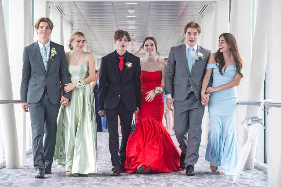 From left, Evan Nadzan, 17, Addie Henderson, 17, Jake Harper, 18, Jalen Plaster, 17, Nico Catalde, 17, and Lexi Rich, 16, are shown, on May 21, 2022, before the start of the Enchanted Forest-themed McDowell High School prom at the Sky Bridge of the Bayfront Convention Center in Erie. The Sky Bridge affords scenic views of Erie, including the bay, and connects the Bayfront Convention Center to the Sheraton Erie Bayfront Hotel.