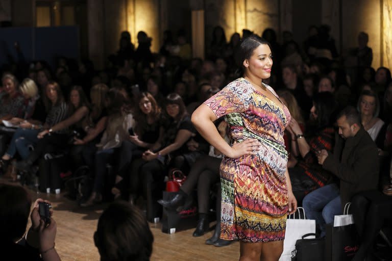 A plus-size model on the catwalk at Shoreditch Town Hall, east London, today. Here, elegantly-dressed women browse racks of clothes designed for European size 40 (UK size 12, US size 8 or 10) and upwards, snacking intermittently from plates of crisps and cupcakes spread around the venue -- food here is not taboo