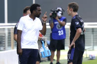 CF Montreal head coach Wilfried Nancy, left, talks with midfielder Lassi Lappalainen during the second half of an MLS soccer match against Columbus Crew, Saturday, May 1, 2021, in Fort Lauderdale, Fla. The game ended in a 0-0 tie. (AP Photo/Lynne Sladky)