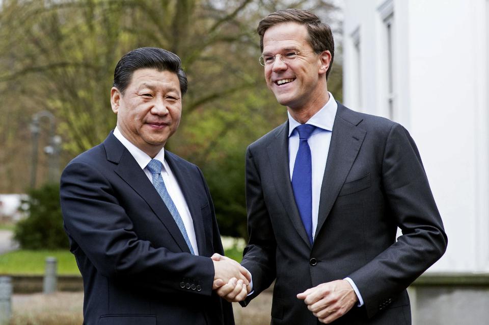 China's President Xi Jinping, left, and Dutch Prime Minister Mark Rutte, right, pose for photographers prior to a meeting at the prime minister's residence in The Hague, Netherlands, Sunday March 23, 2014. Xi is on a two-day state visit ahead of the March 24 and 25 Nuclear Security Summit in The Hague. (AP Photo/Valerie Kuypers, POOL)