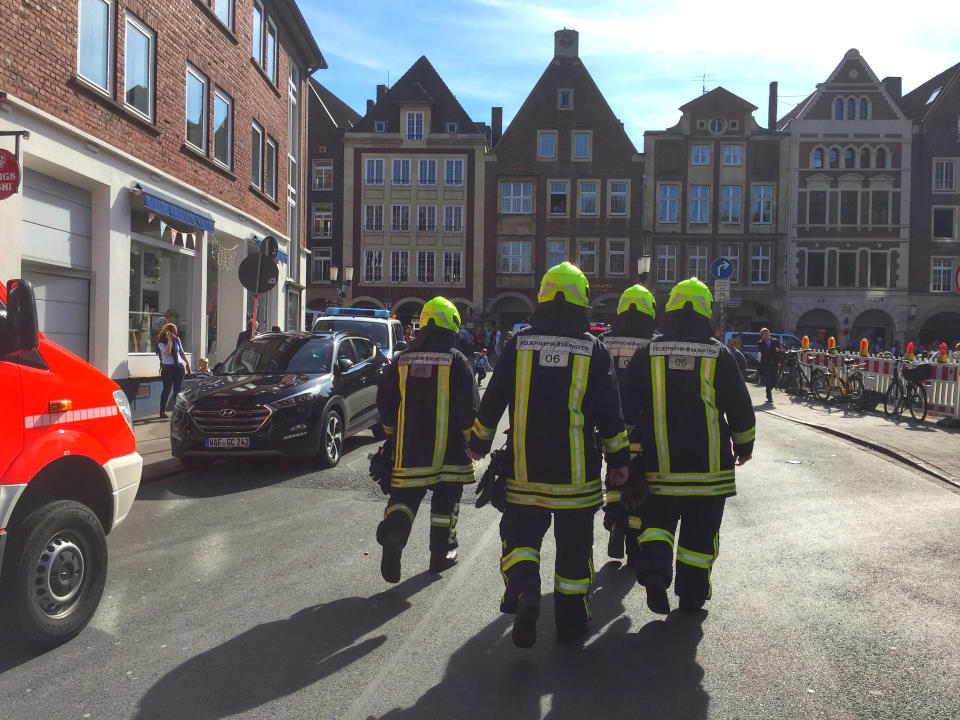 <p>Firefighters walk in downtown Muenster, Germany, Saturday, April 7, 2018. German news agency dpa says several people were killed after car crashes into crowd in the city of Muenster. (Photo: dpa via AP) </p>