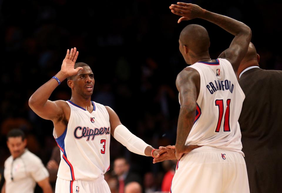 Chris Paul (3) and Jamal Crawford (11) of the Los Angeles Clippers celebrate in the final minute of the game against the Los Angeles Lakers at Staples Center on October 31, 2014, in Los Angeles, Calif. The Clippers won 118-111.