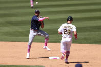 Tampa Bay Rays' Willy Adames, left, throws to first as Oakland Athletics' Matt Chapman goes into second base on a double play hit by Seth Brown during the sixth inning of a baseball game in Oakland, Calif., Sunday, May 9, 2021. (AP Photo/Jed Jacobsohn)