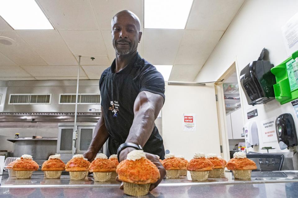 Football player-turned-baker Donavon "Monty" Alderman shows off a strawberry cupcake to be given out as part of Monty's Neighborhood Snacks' mission to help improve the quality of life for everyone by providing survival, living, education and employment skills through community service while providing amazing treats at the Police Athletic League of Wilmington on Wednesday, Dec. 7, 2022. Alderman will be a contestant on the Food Network program "Bake It ‘Til You Make It," airing Dec. 26.