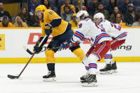 Nashville Predators center Colton Sissons (10) takes a shot as New York Rangers left wing Artemi Panarin (10) tries to slow him down in the second period of an NHL hockey game Thursday, Oct. 21, 2021, in Nashville, Tenn. (AP Photo/Mark Humphrey)